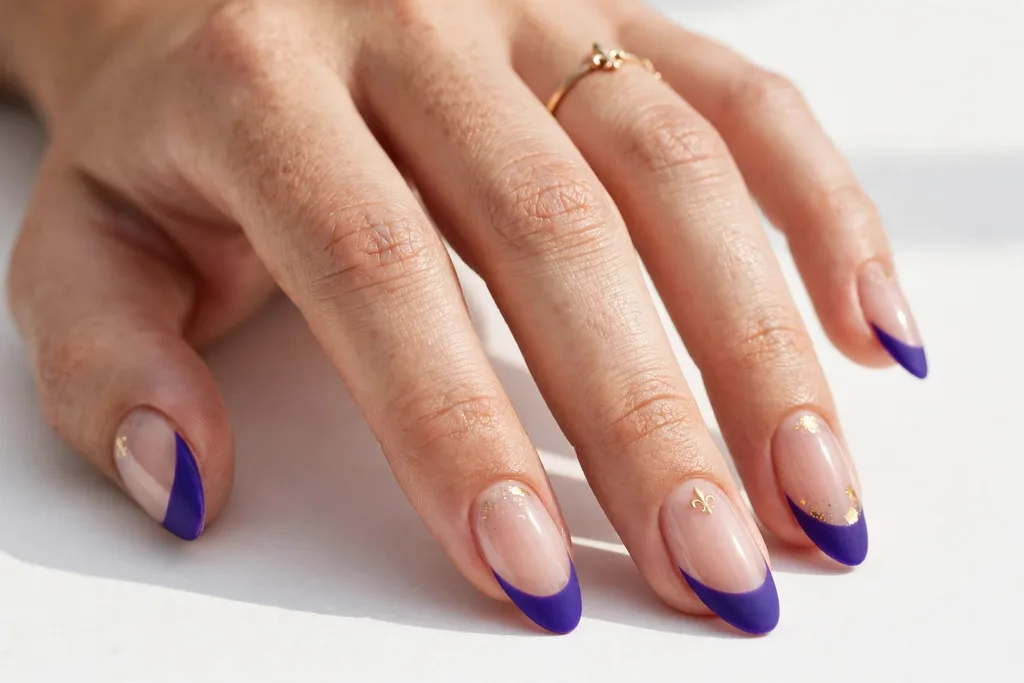 Matte Purple Mardi Gras French Tip Nails Mardi Gras French tip nails with matte royal purple tips on a sheer nude base, shown on medium almond nails.